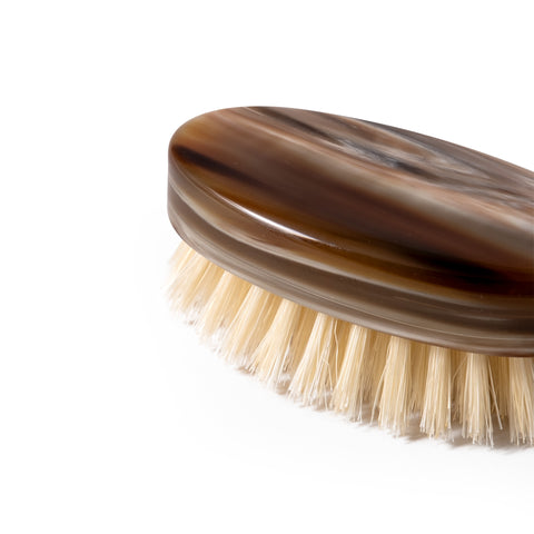Detail of luxury beard and moustache brush in natural horn with natural bristles, handmade in Italy
